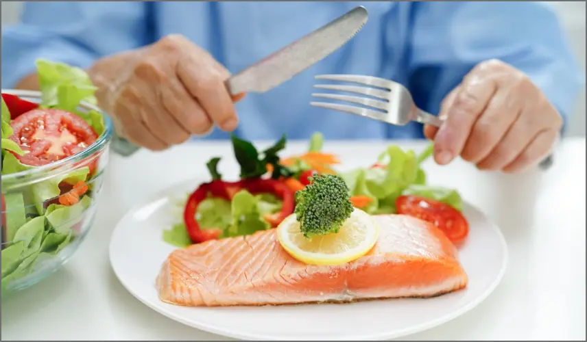 senior eating salmon personalized meal golden valley services and amenties