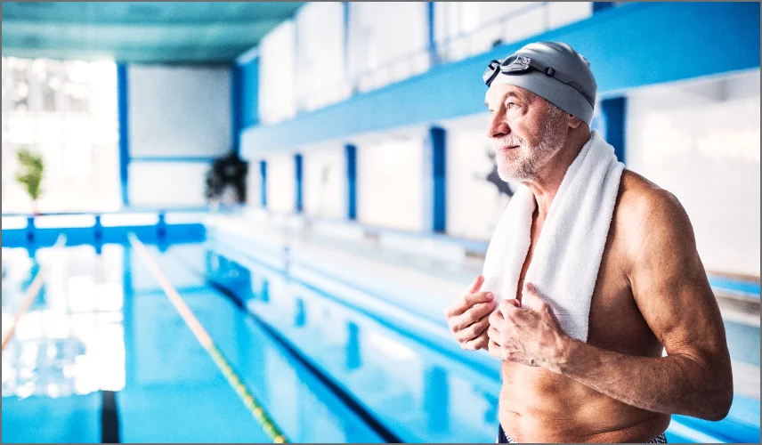 senior man swimming at golden valley pool senior living services